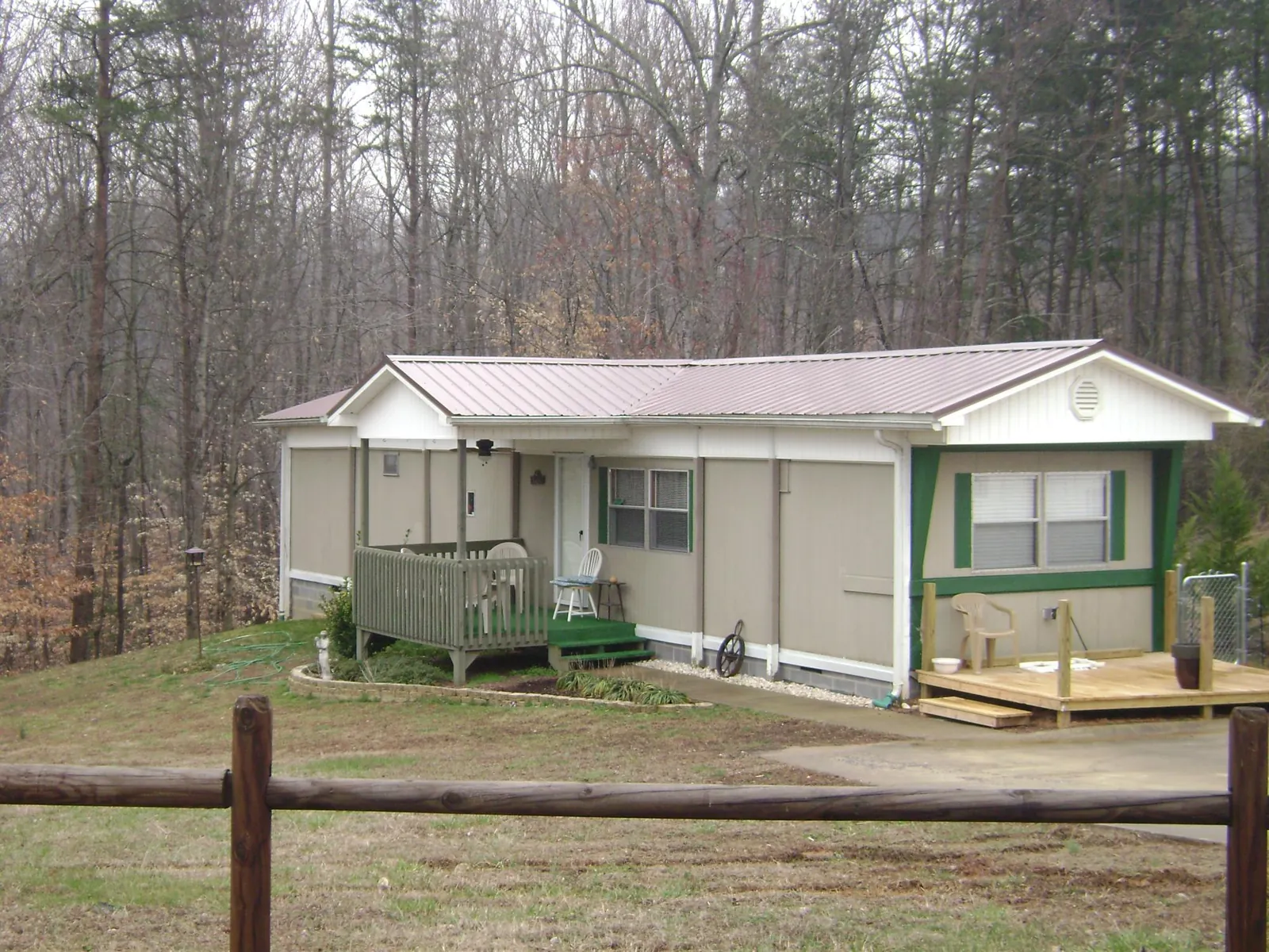 Mauve metal roof on a manufactured home with a new front deck in Ronco
